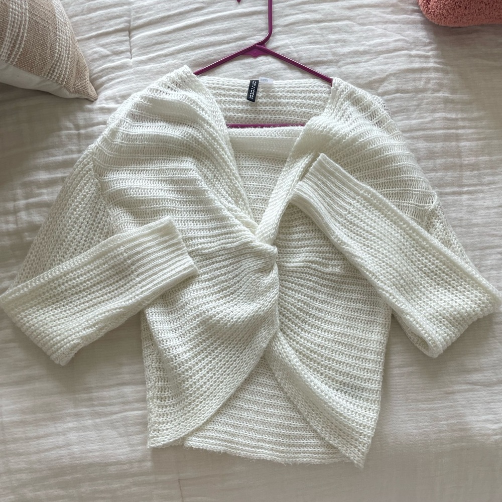 White sweater with knot in front.
